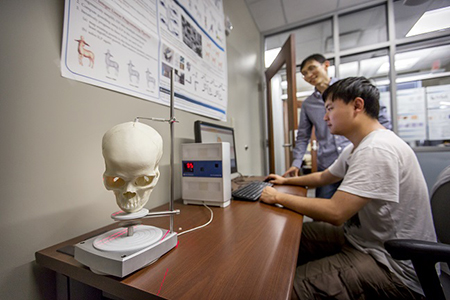 Members of LSU's Geometric and Visual Computing Group scan a human skull to make a 3D model