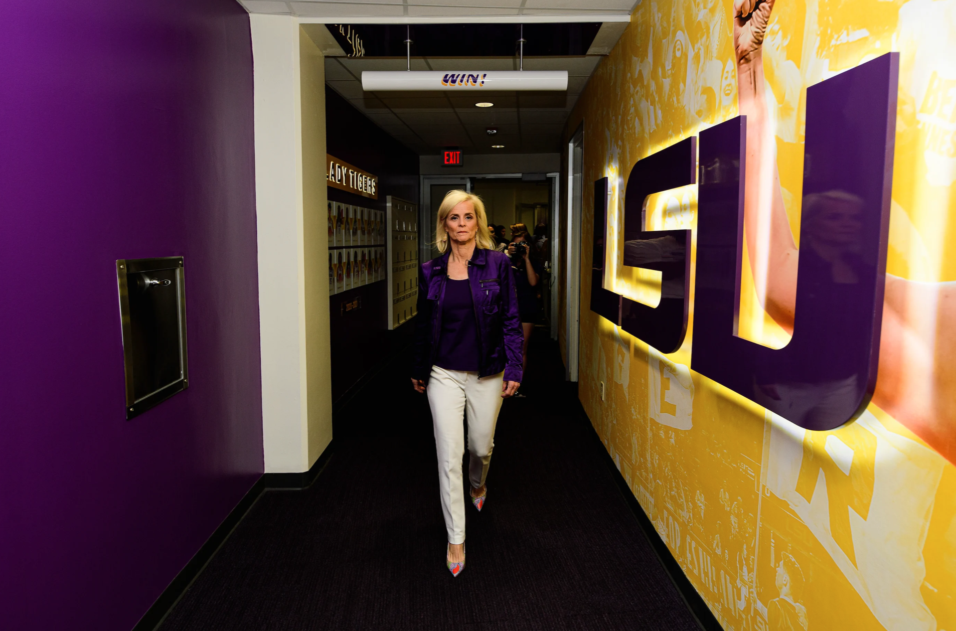 Coach Kim Mulkey walks to the LSU Women’s Basketball locker room at her introductory homecoming event. 