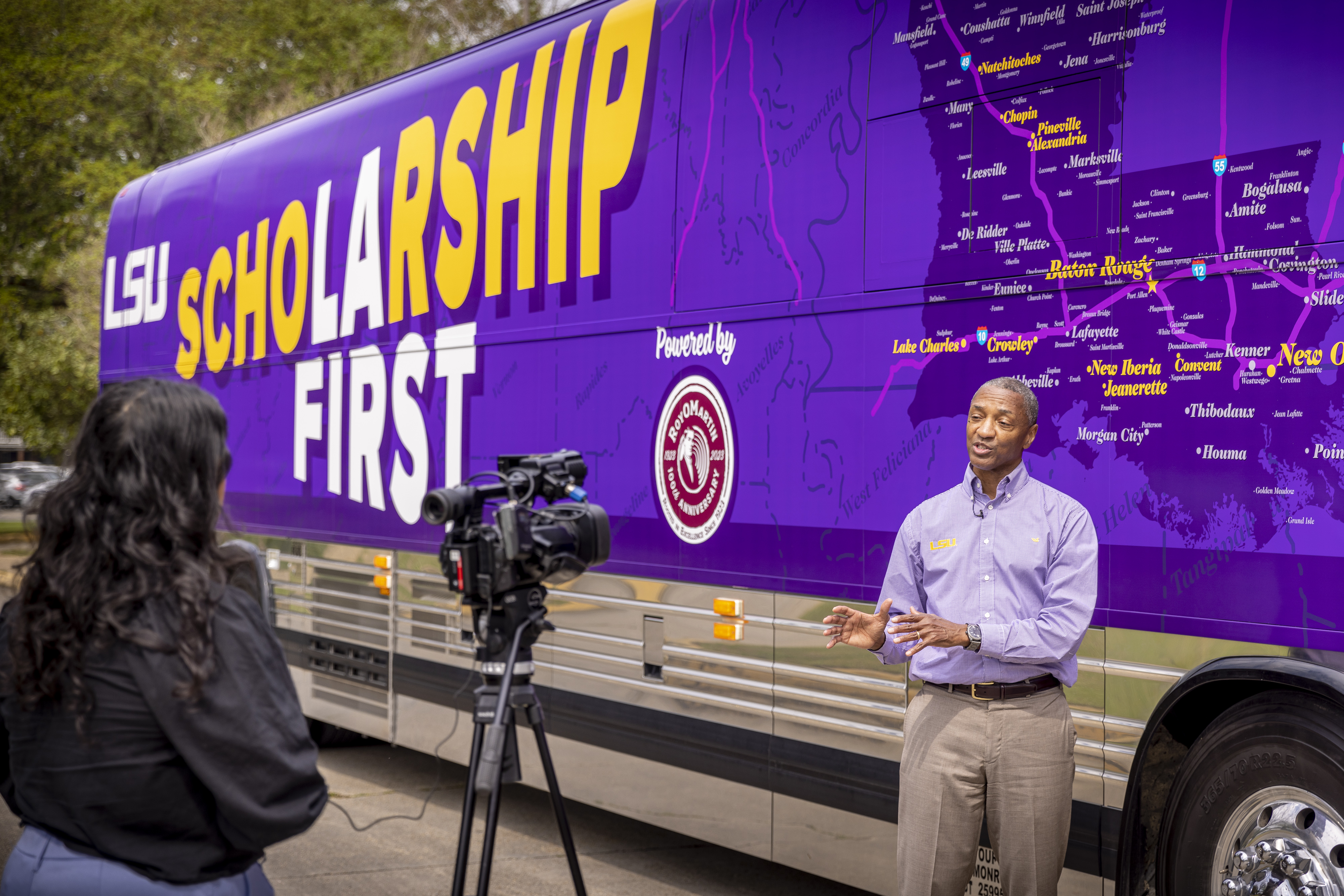 LSU President William F. Tate IV gives an interview in front of the Scholarship First tour bus Friday on the LSU campus.