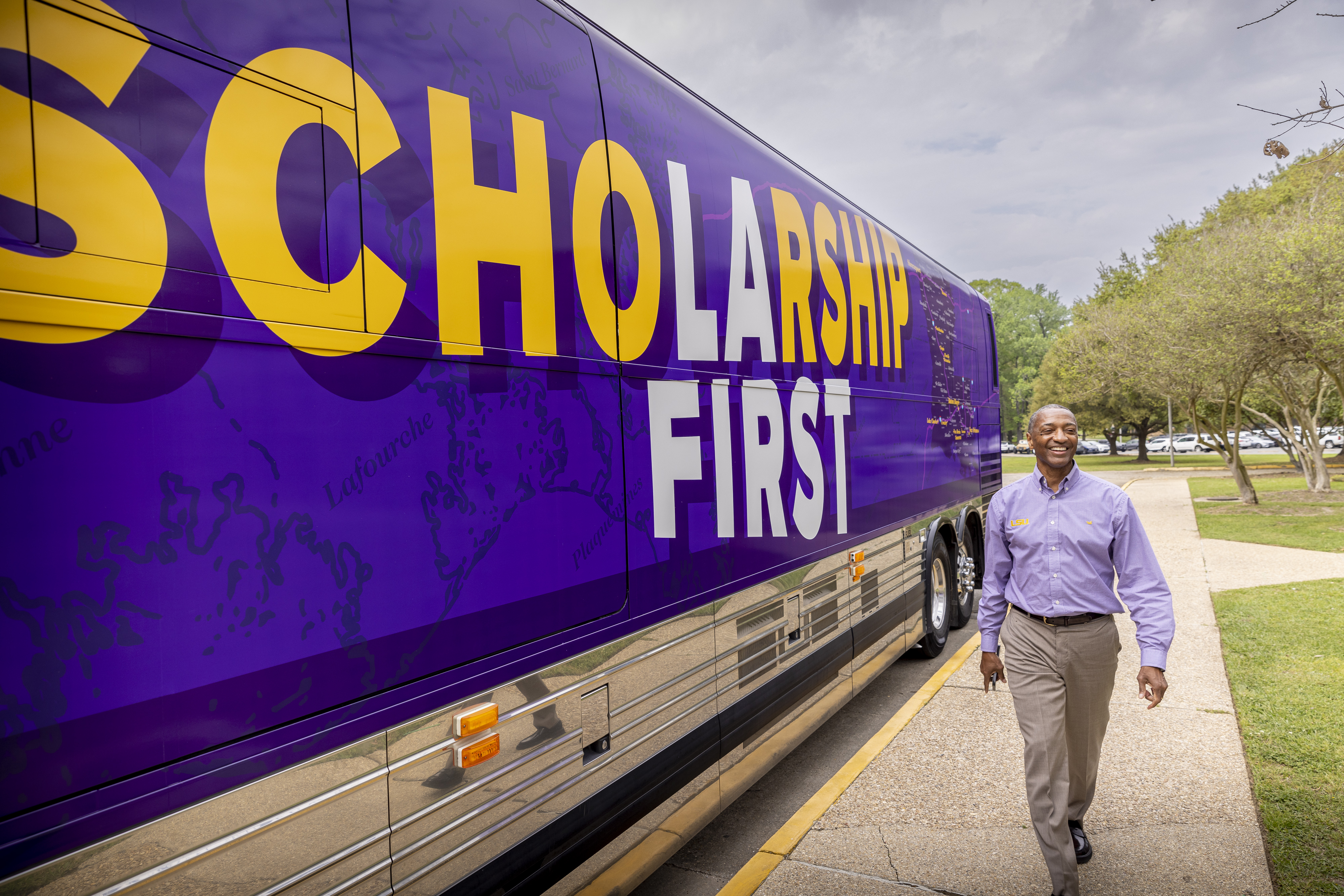 LSU President William F. Tate IV inspects the Scholarship First tour bus Friday on the LSU campus.