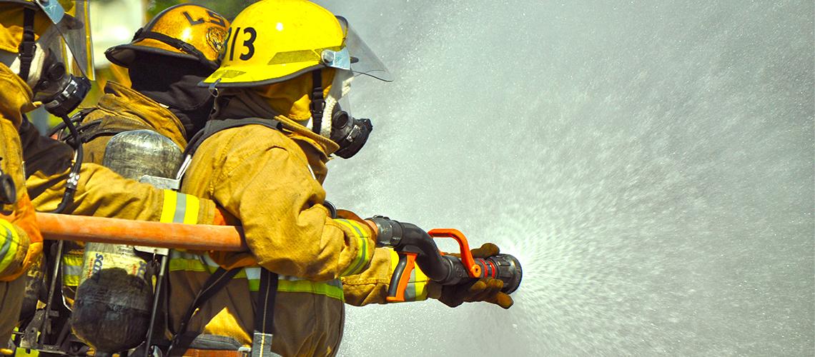 Firemen using a hose