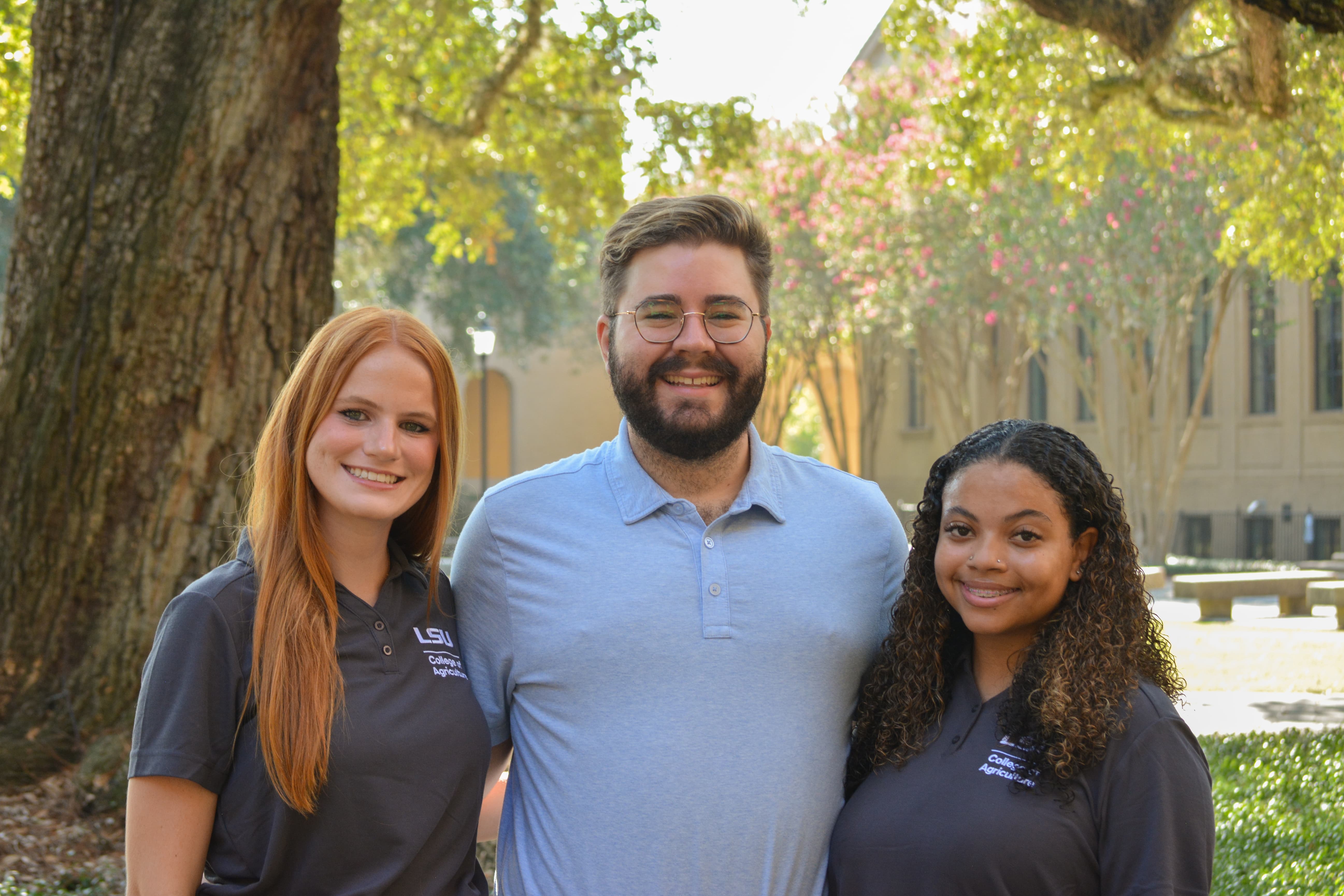 Jonathan Thomas stands with peer mentors Rylie Hutchinson and Madison Albert