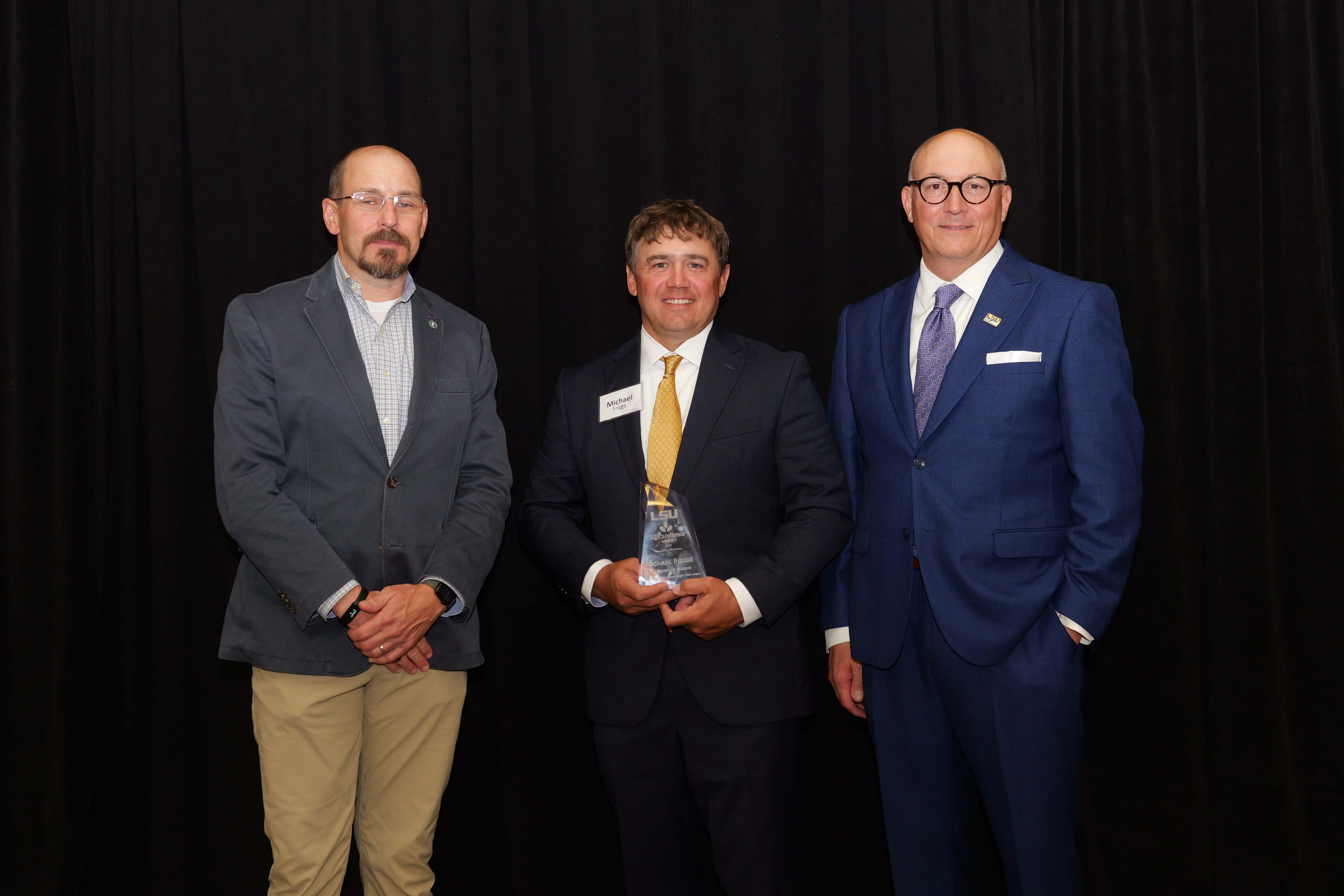 Michael Fruge recieving an alumni award Michael Fruge recieving an alumni award from Matt Lee