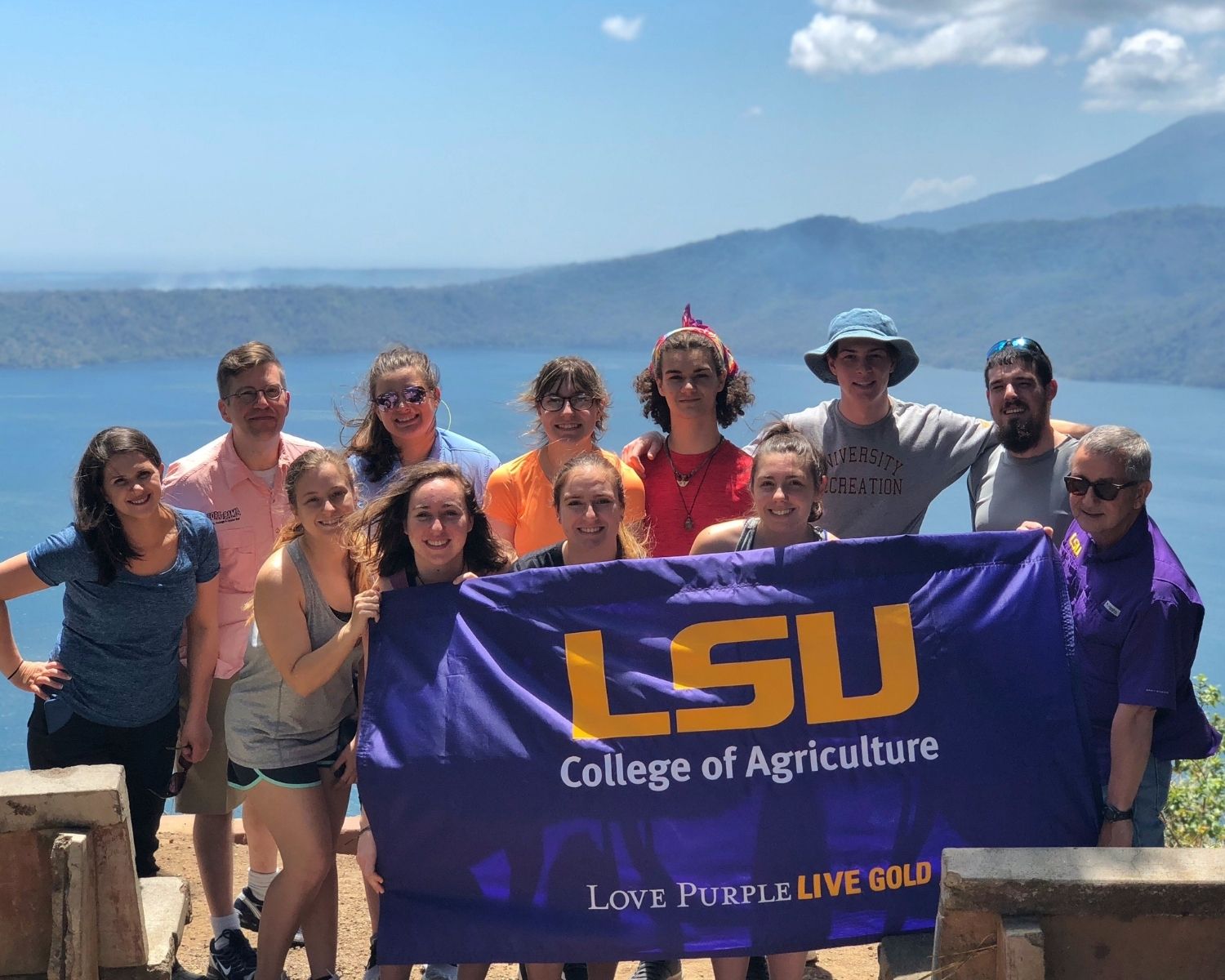 Students hold LSU Collge of Agriculture flag