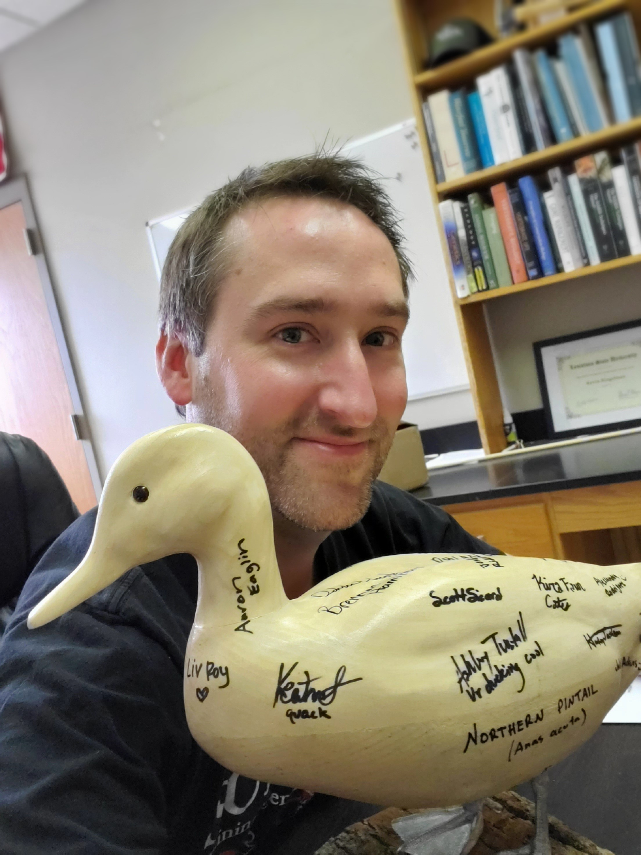 Kevin Ringelman, shown here with a duck carving given to him by his students