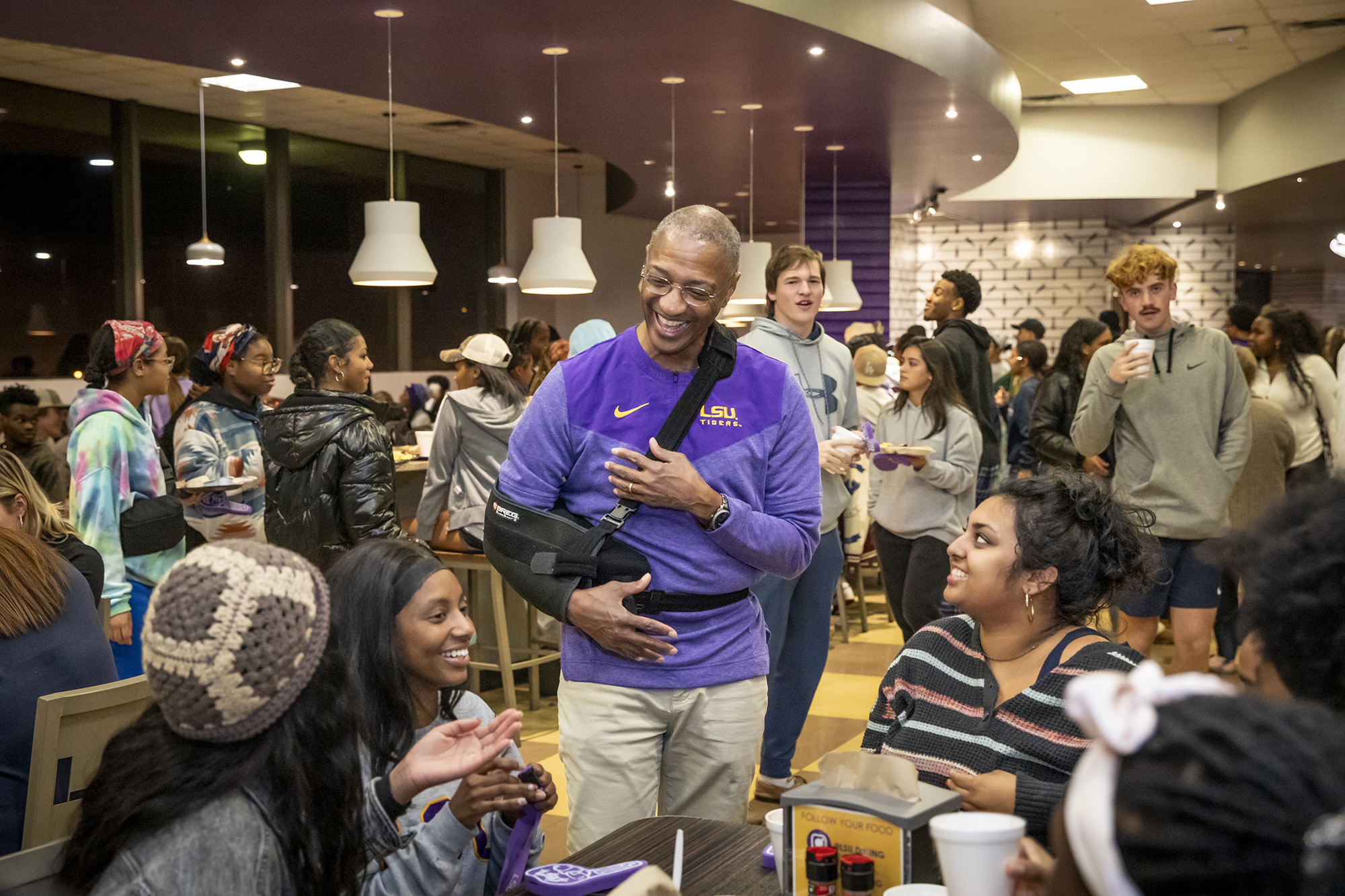 President Tate laughs with students at the President's Late Night Breakfast