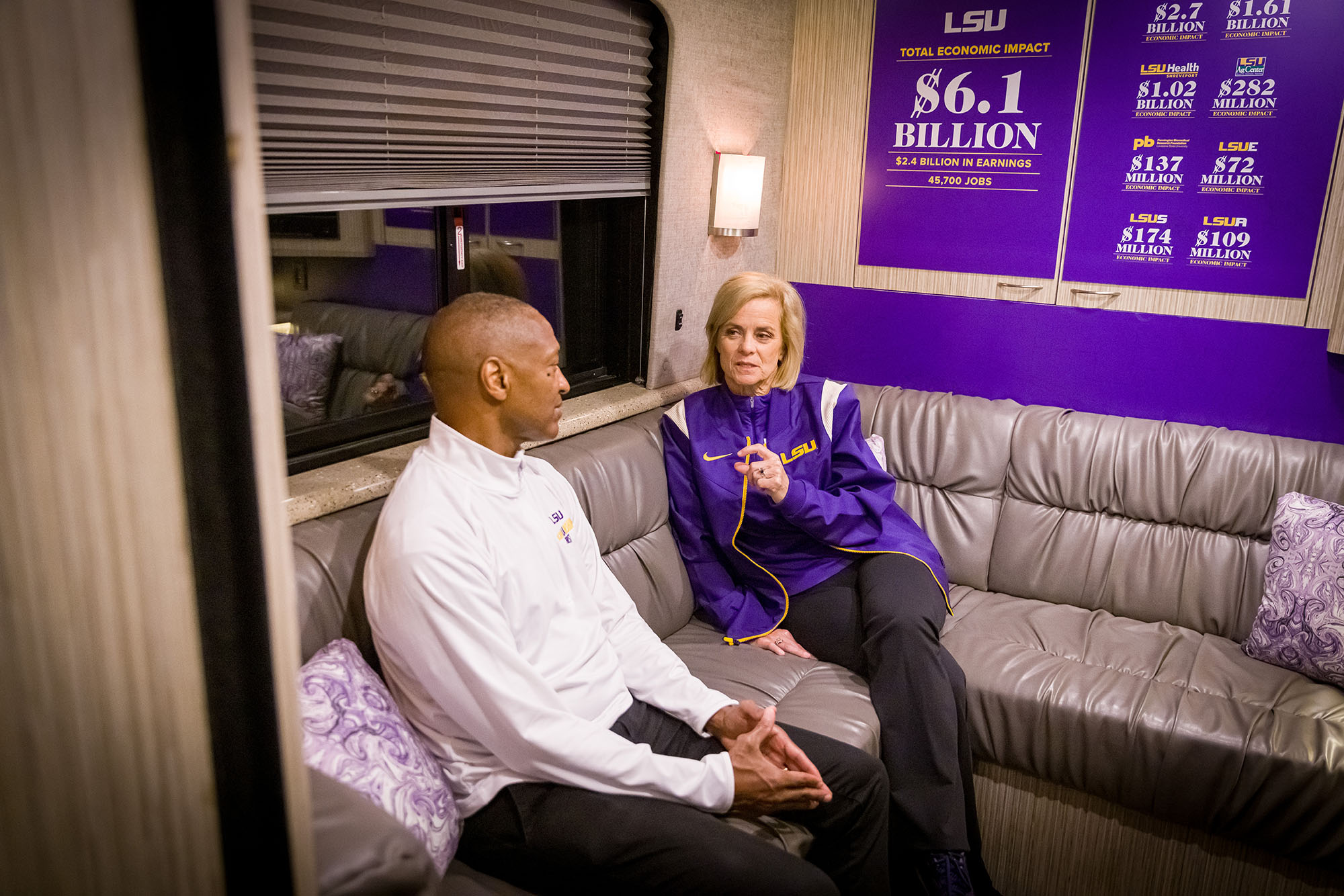 LSU President William F. Tate IV and Coach Kim Mulkey about the Scholarship First bus