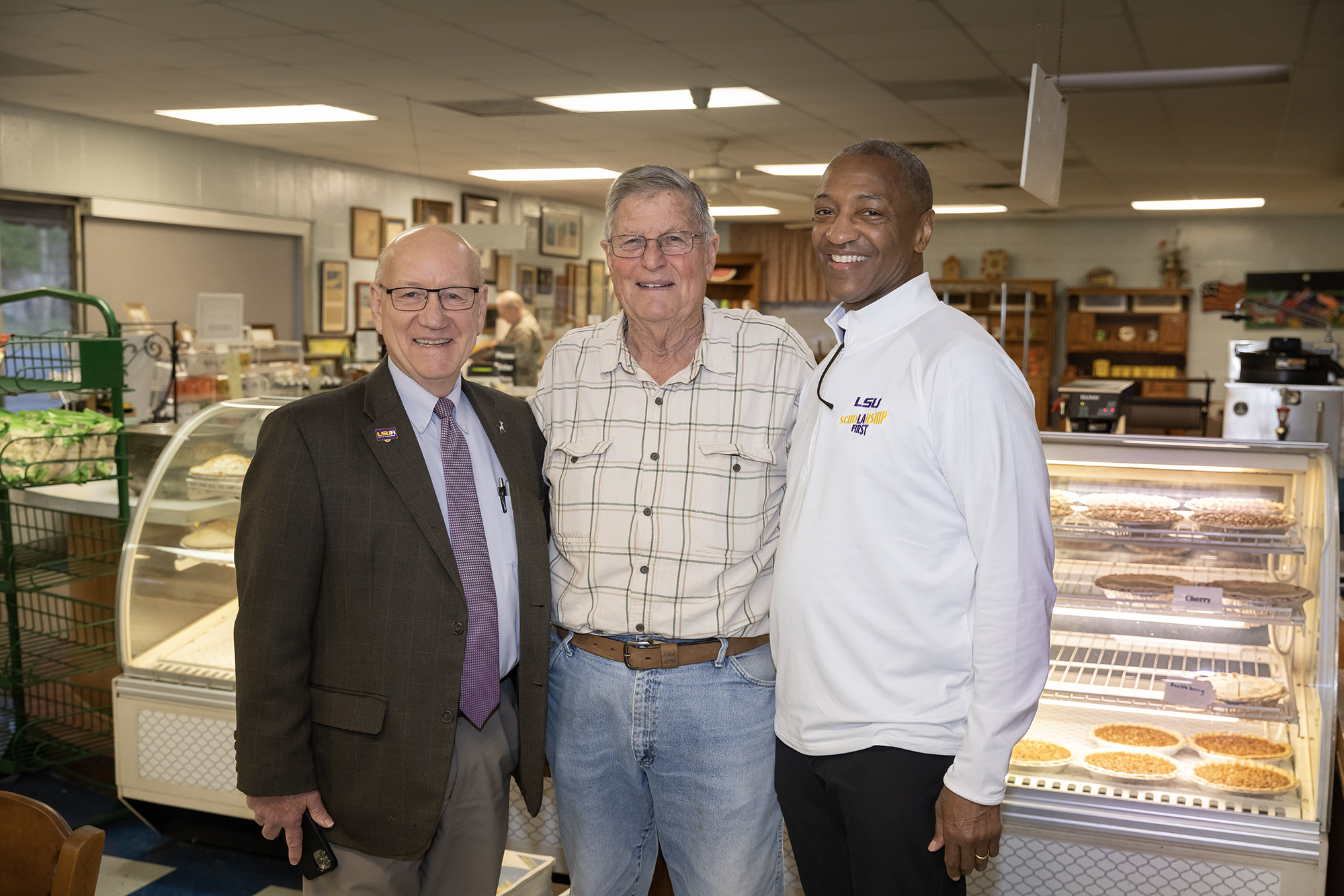 President Tate with two men inside Lea's Lunchroom