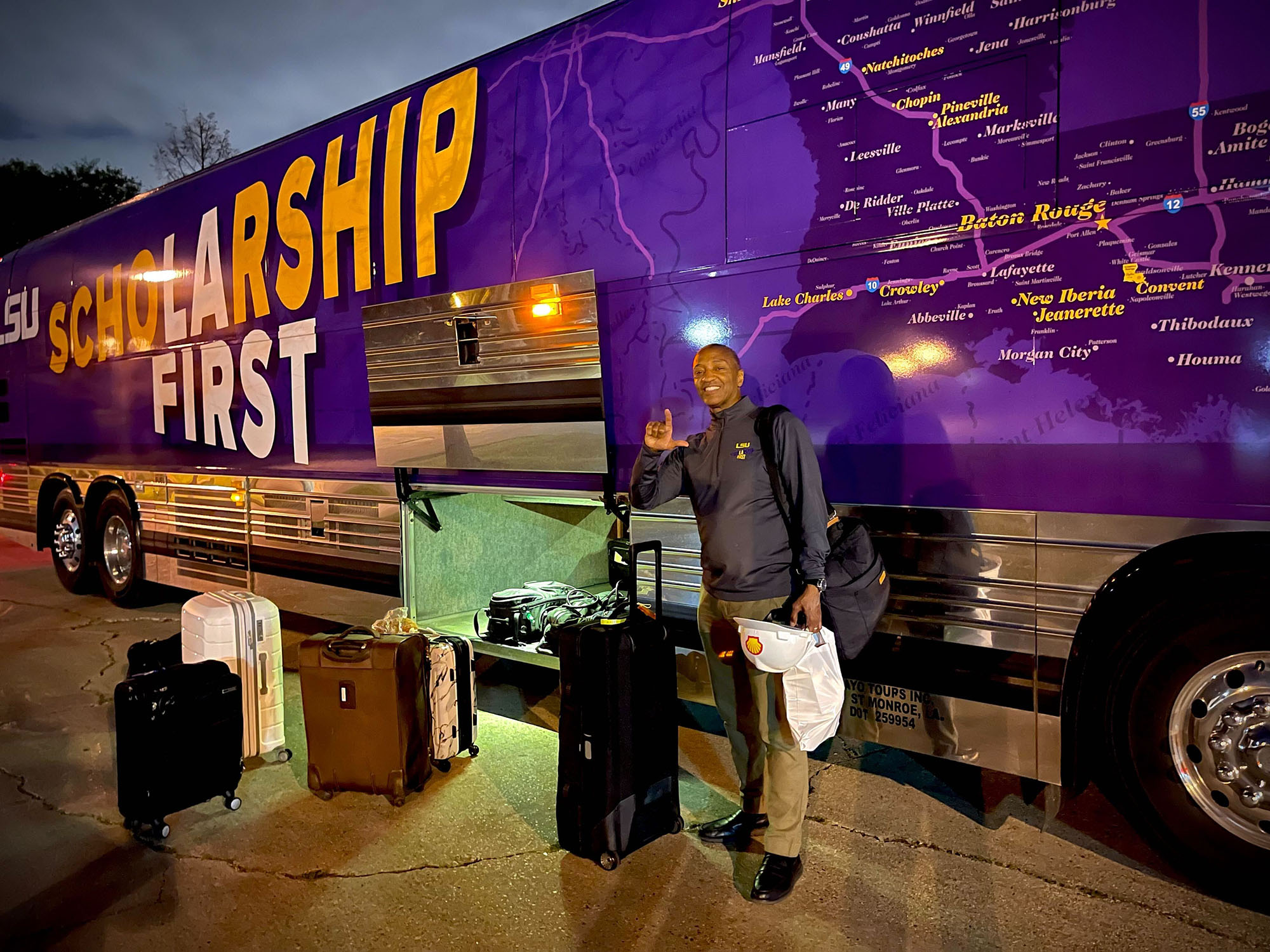 President Tate loading luggage onto the tour bus