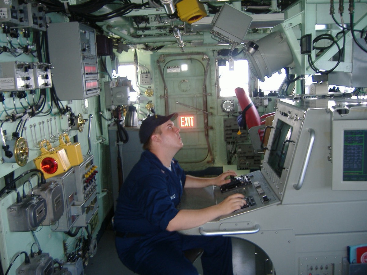 Scott Sonnier operates specialized equipment aboard a Navy vessel during his service.