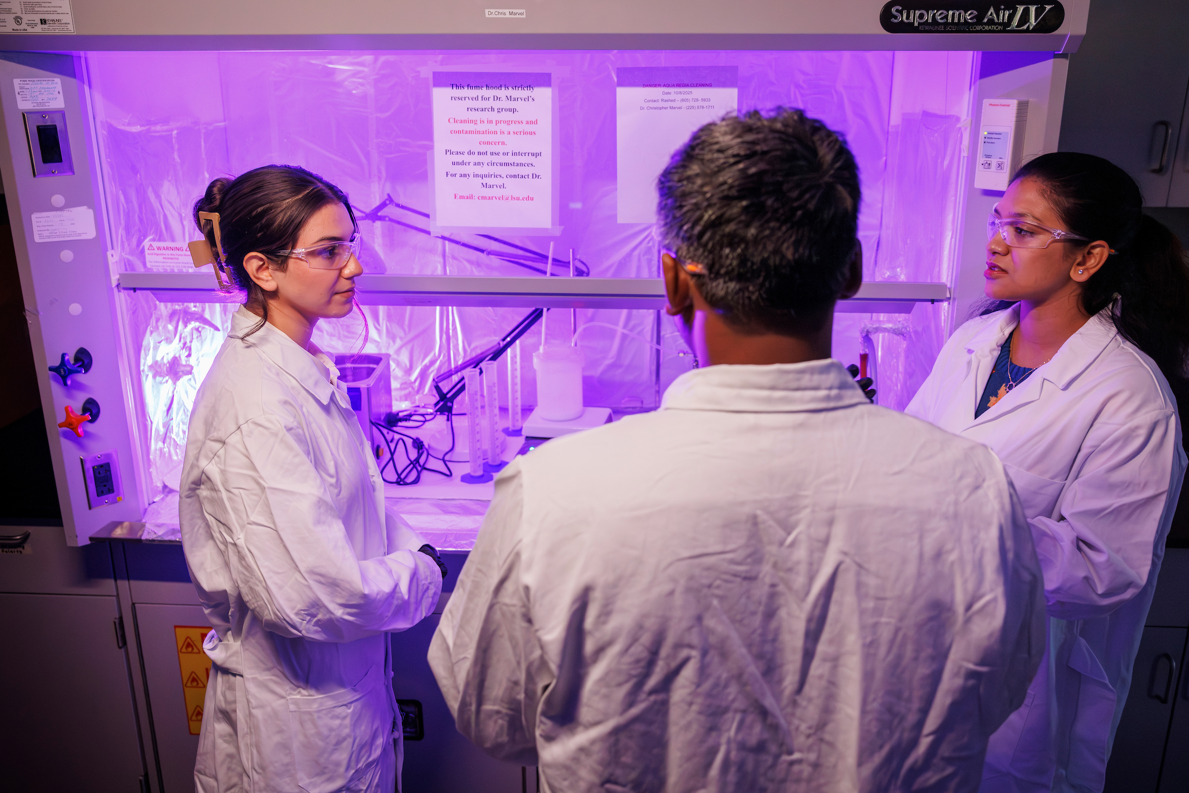 Researchers collaborate in lab.