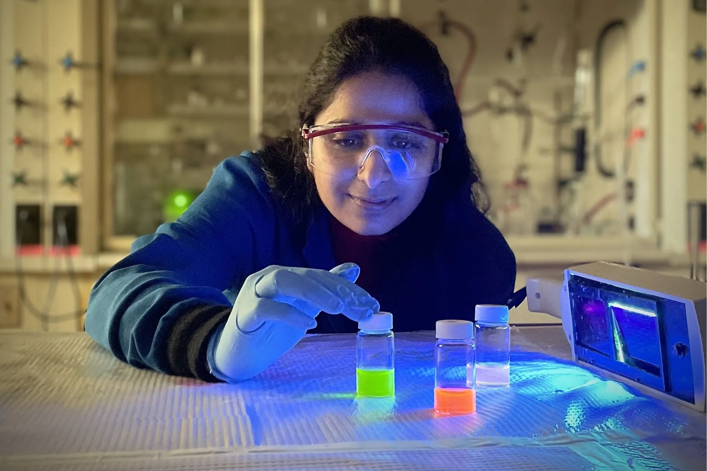 Chemistry student wearing goggles working in a lab.