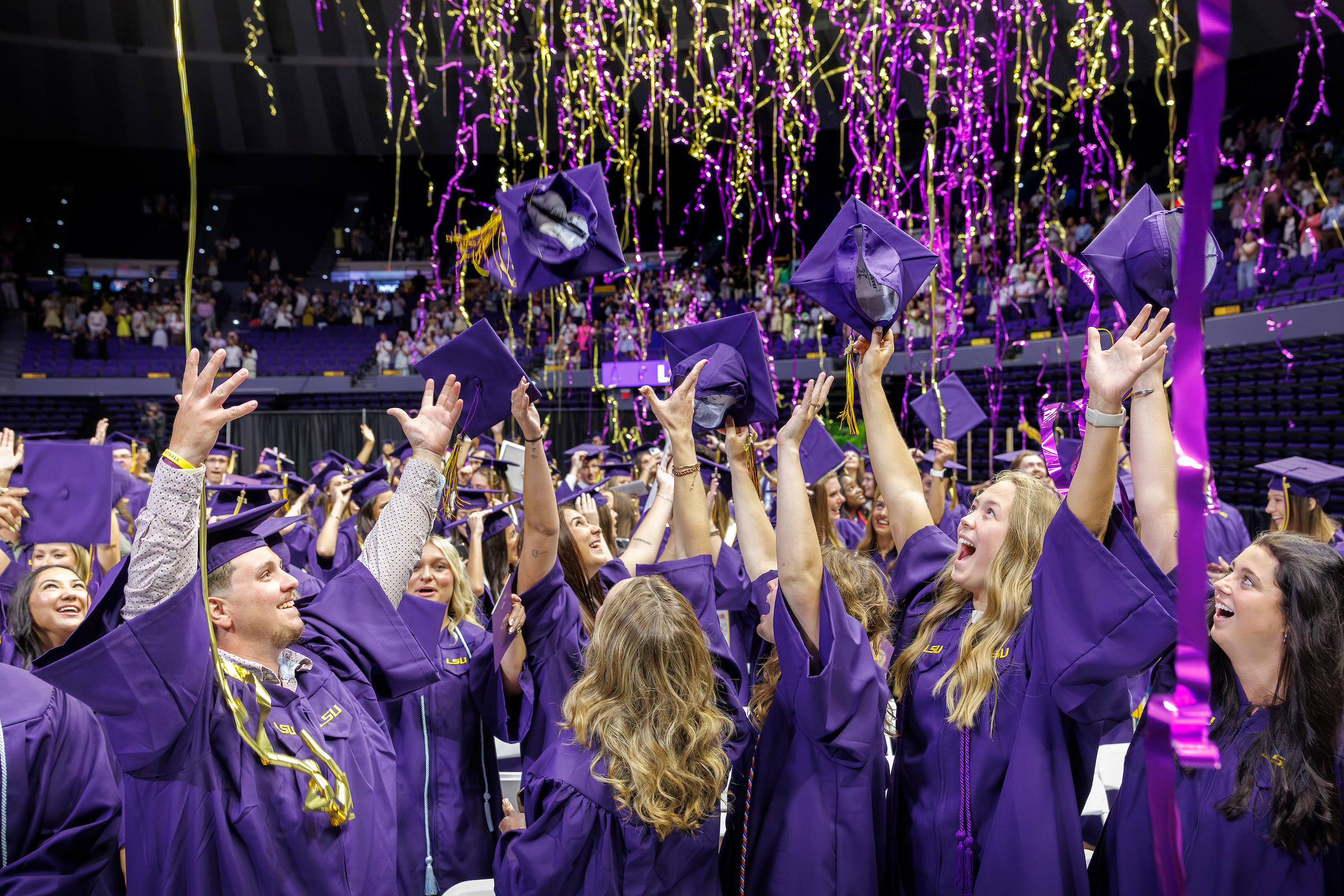 Graduates celebrate with streamers falling from the ceiling