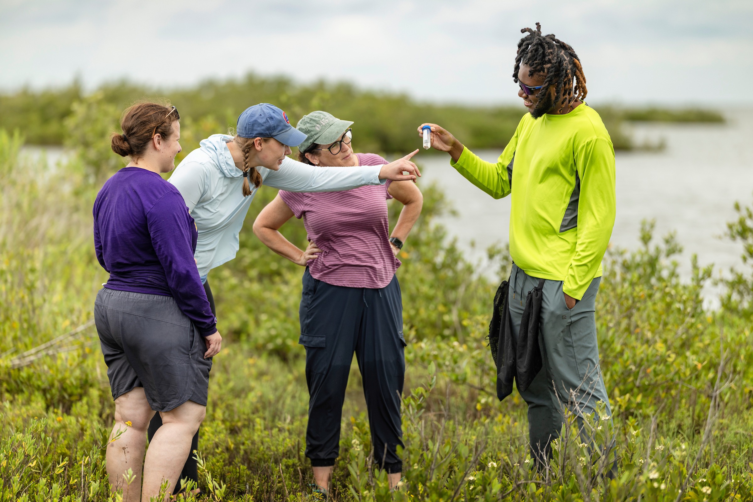 LSU graduate student Ahmani Brown leads his thesis research examining how black mangrove expansion affects marsh periwinkle snails in Louisiana coastal marshes. Brown works alongside advisor Dr. Morgan Kelly and postdoctoral researchers Katherine Eaton and Isabelle Neylan to collect and study specimens in the field.