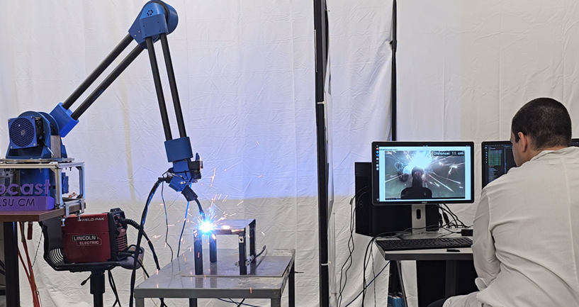 A specialized haptic controller and assistive functions allows workers to remotely operate a telerobotic welding robot from great distances. 