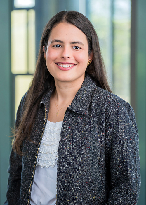 Marcella Teixera Gonzaga wears a white blouse and mottled black and white jacket.