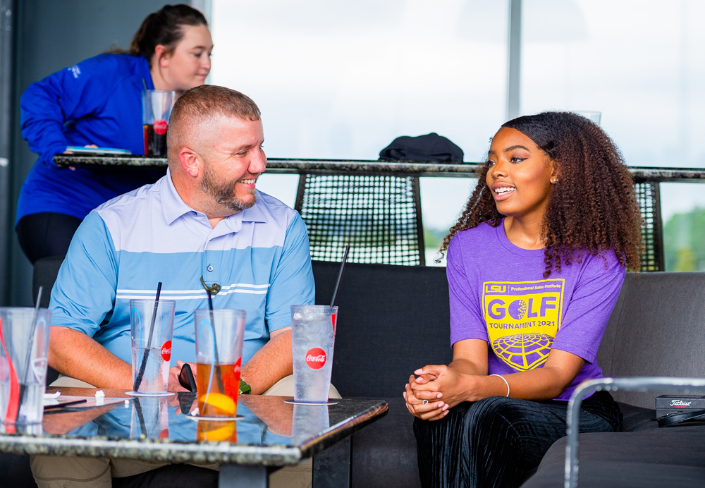 PSI sponsor and student have a conversation at TopGolf