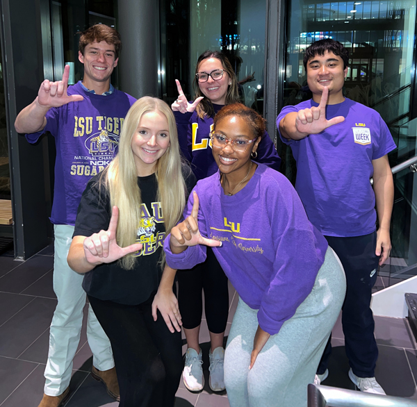 The five students on LSU's Audit Innovation Campus Challenge team smile at the camera and hold up Ls