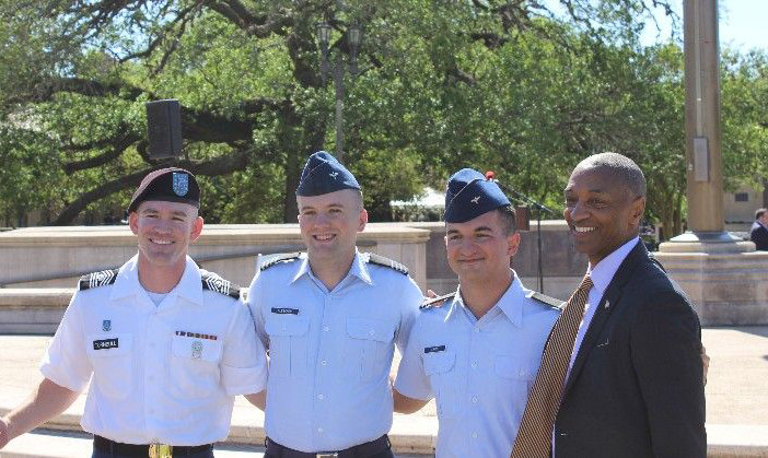 Several cadets stand with LSU President William F. Tate IV, Austin Firmin is standing directly beside the president.