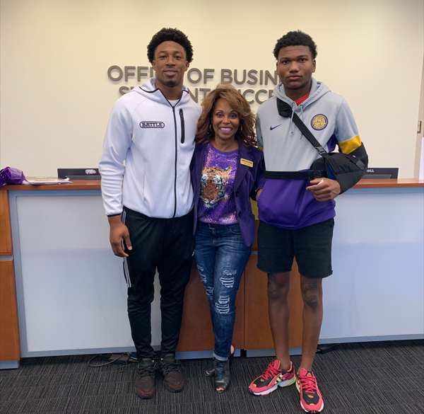 Sonja Wiley in the office of business student success with two LSU football recruits