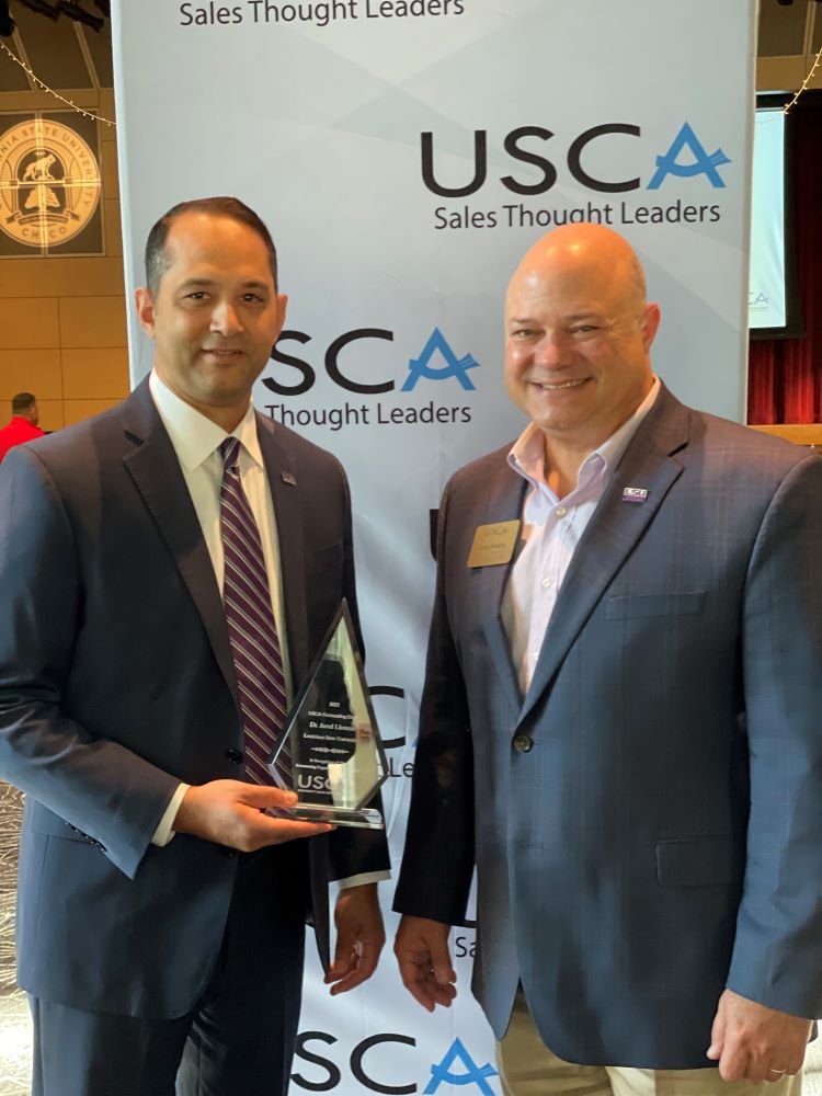 Dean Jared Llorens and Greg Accardo as Llorens holds his USCA Dean Award.