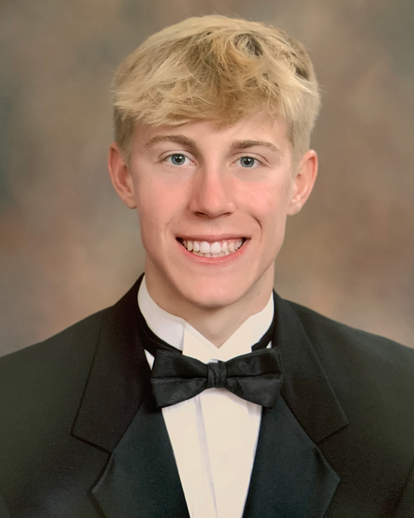 Britton LeBlanc in a studio photo wearing a tux. He smiles warmly.