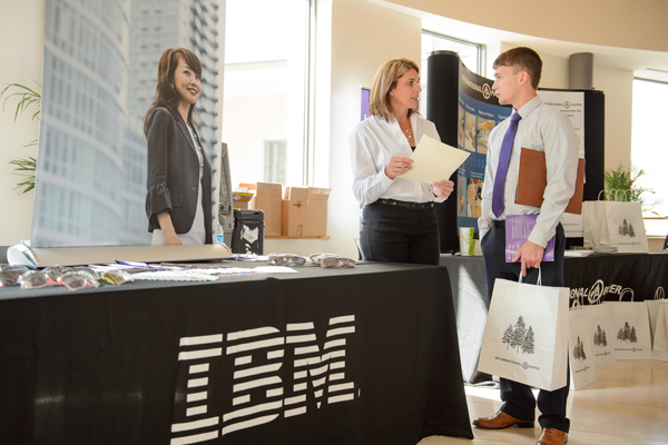 student speaks to IBM representative at career fair