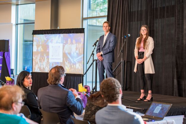 two students present on stage at venture challenge