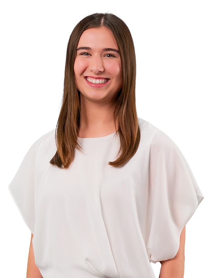 In this headshot, Macy McCalip wears a white flowy blouse and black pants. Her hair is smooth and straight. She is smiling.
