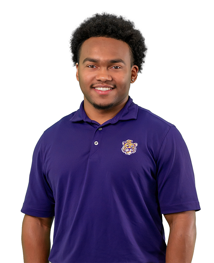 Mekhi Glover has a bright smile in this headshot. He is wearing an LSU polo shirt with a retro Mike mascot icon.