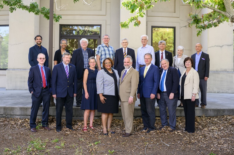 Group of people pose in front of the ECE building