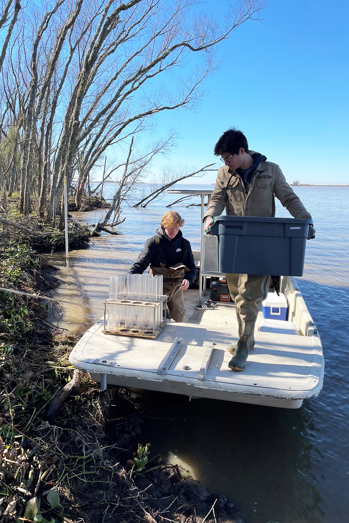 men in a boat loading equipment