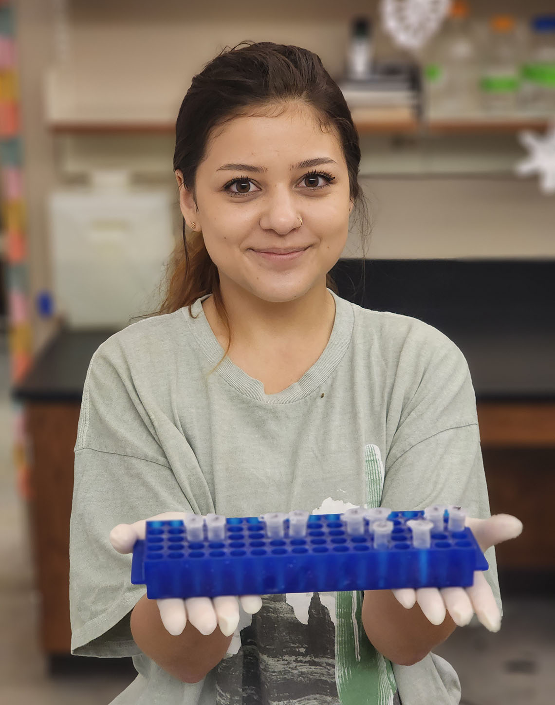 Maile Braden holds specimen tubes