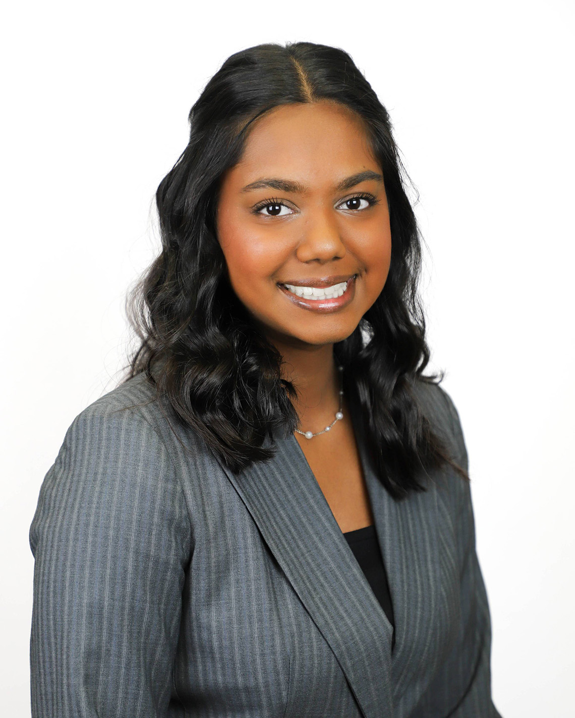 A portrait of a woman in a gray suit