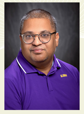 A man with glasses in a purple LSU polo shirt
