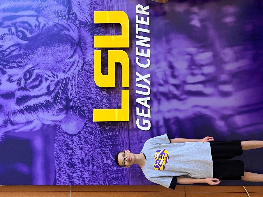 male standing in front of LSU sign