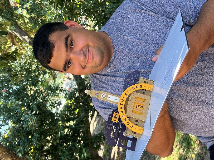 male holding LSU acceptance letter