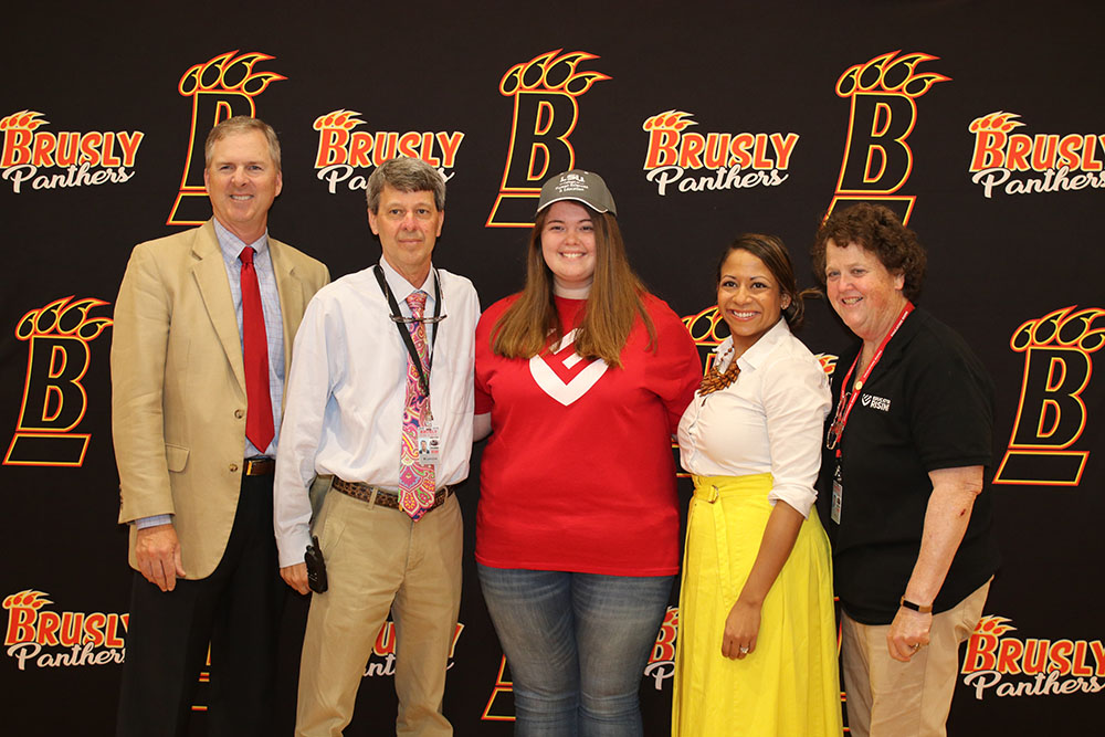 Brusly Administrators and Teachers pose with LSU bound students
