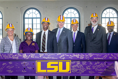 Photo of Huey P. Long Field House Beam Signing. Kari Stephens is second from the left.