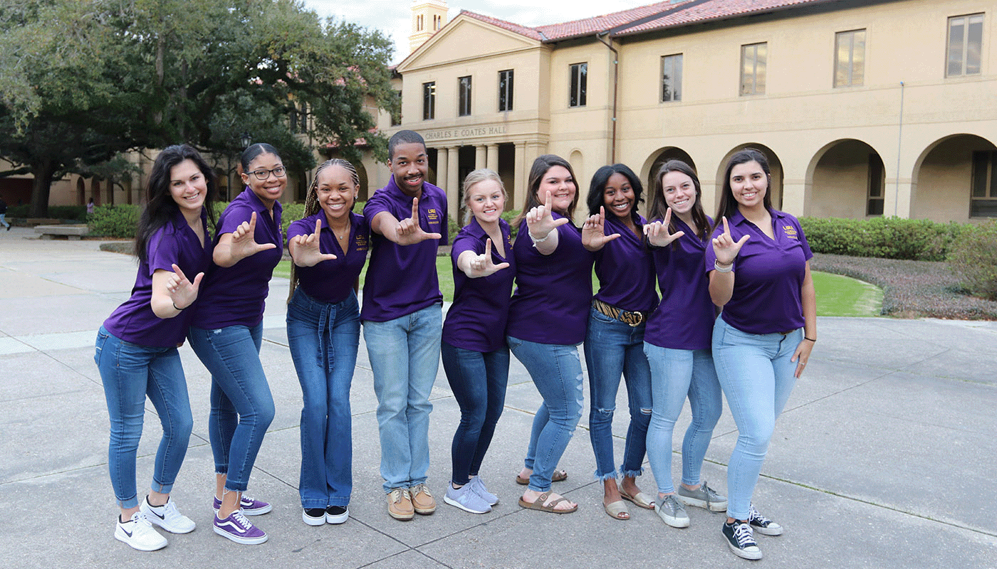 LSU students holding their hand in the shape of an L