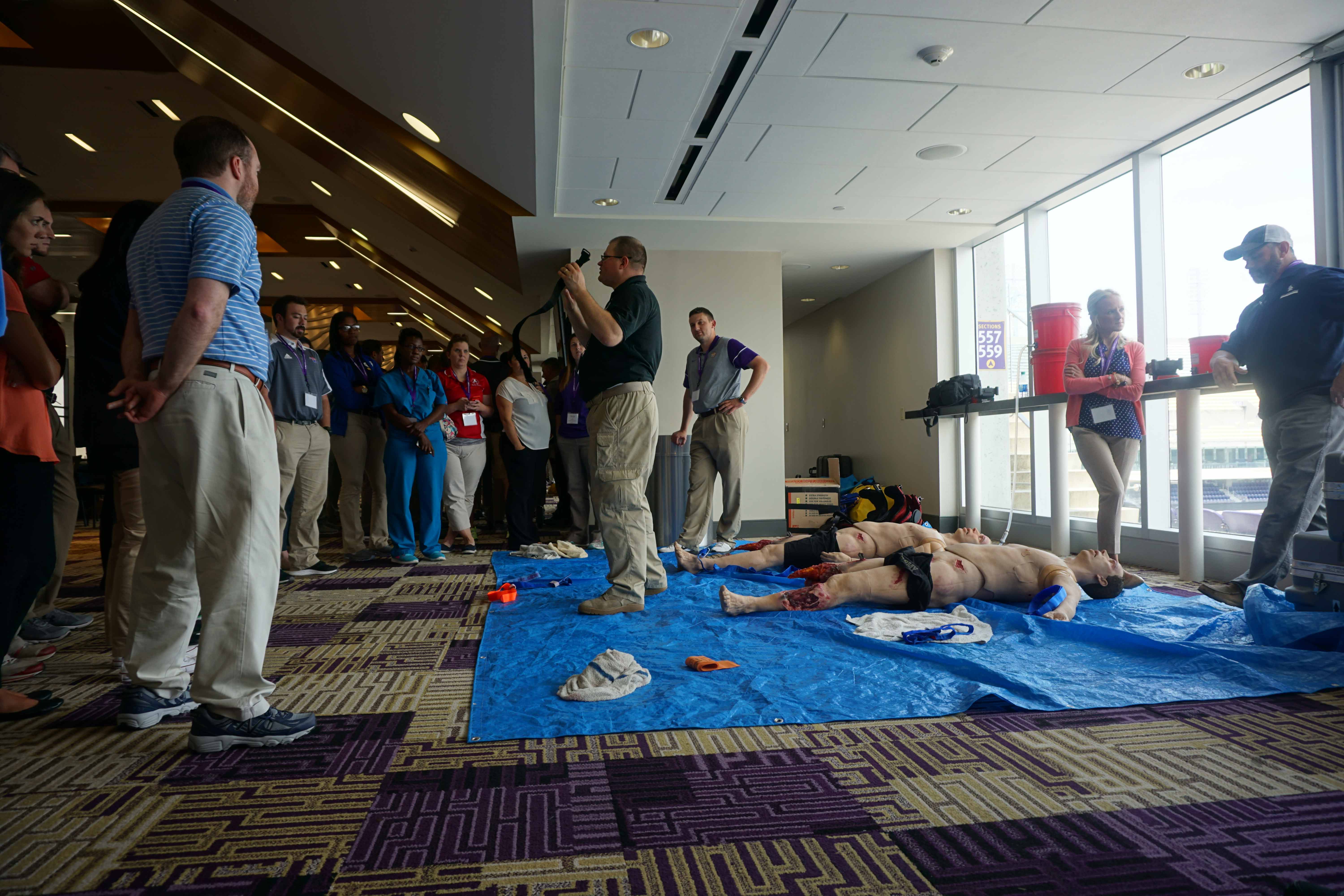 Photo of Emergency Care Course participants with tourniquet training prop