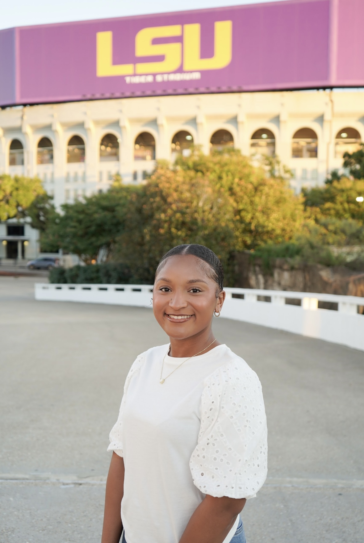 Paris Bickham standing in front of the LSU sign in LSU Tiger Stadium
