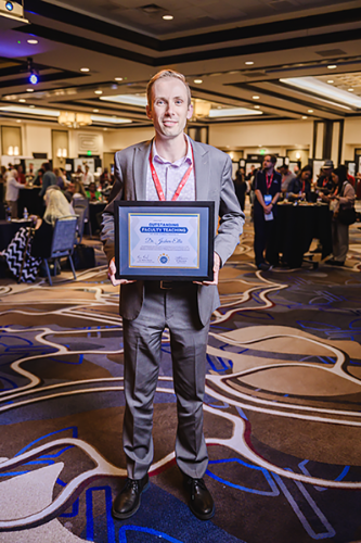 Josh Ellis holding his USEA Award