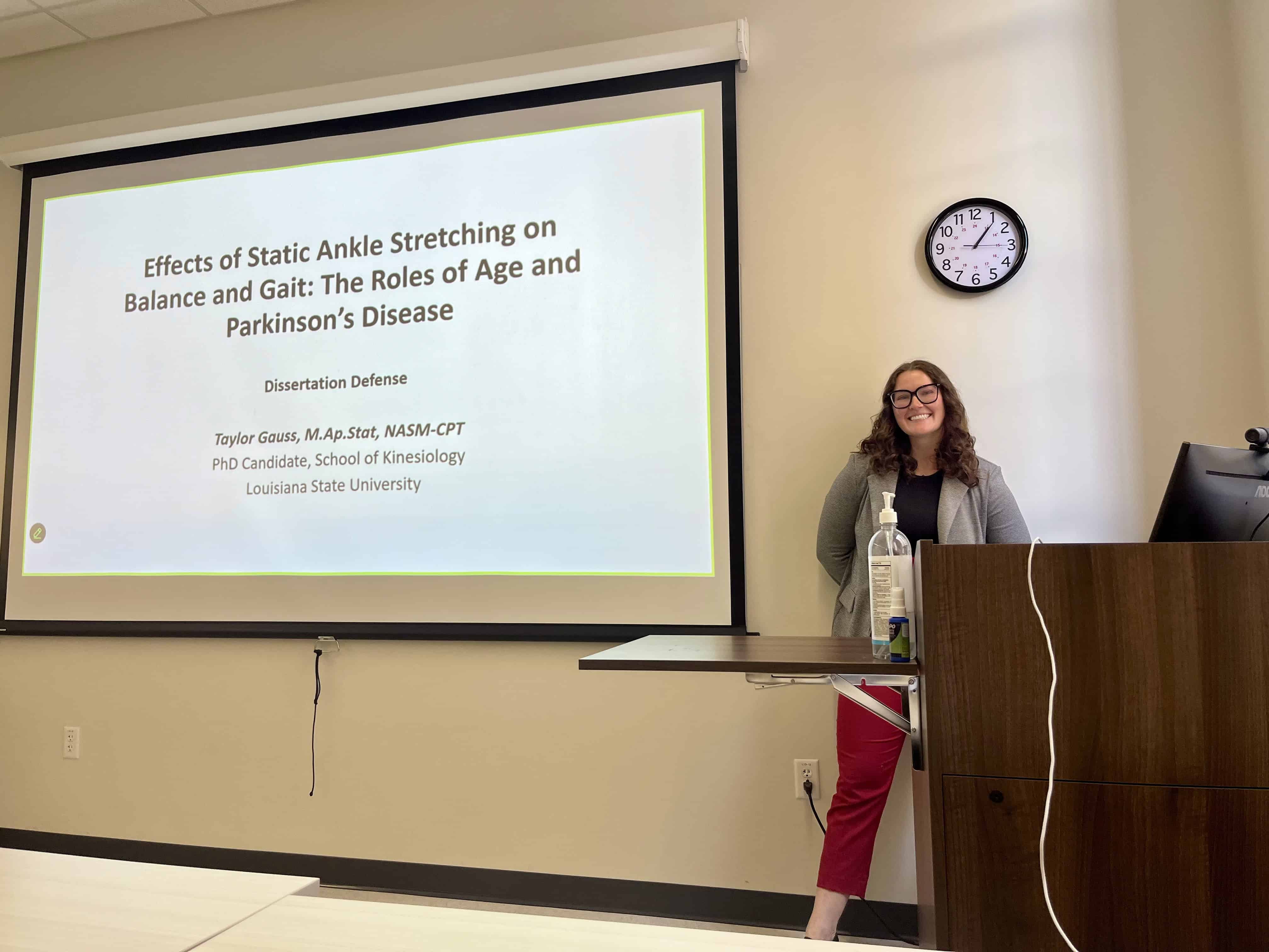 Taylor Gauss giving a presentation about ankle stretching