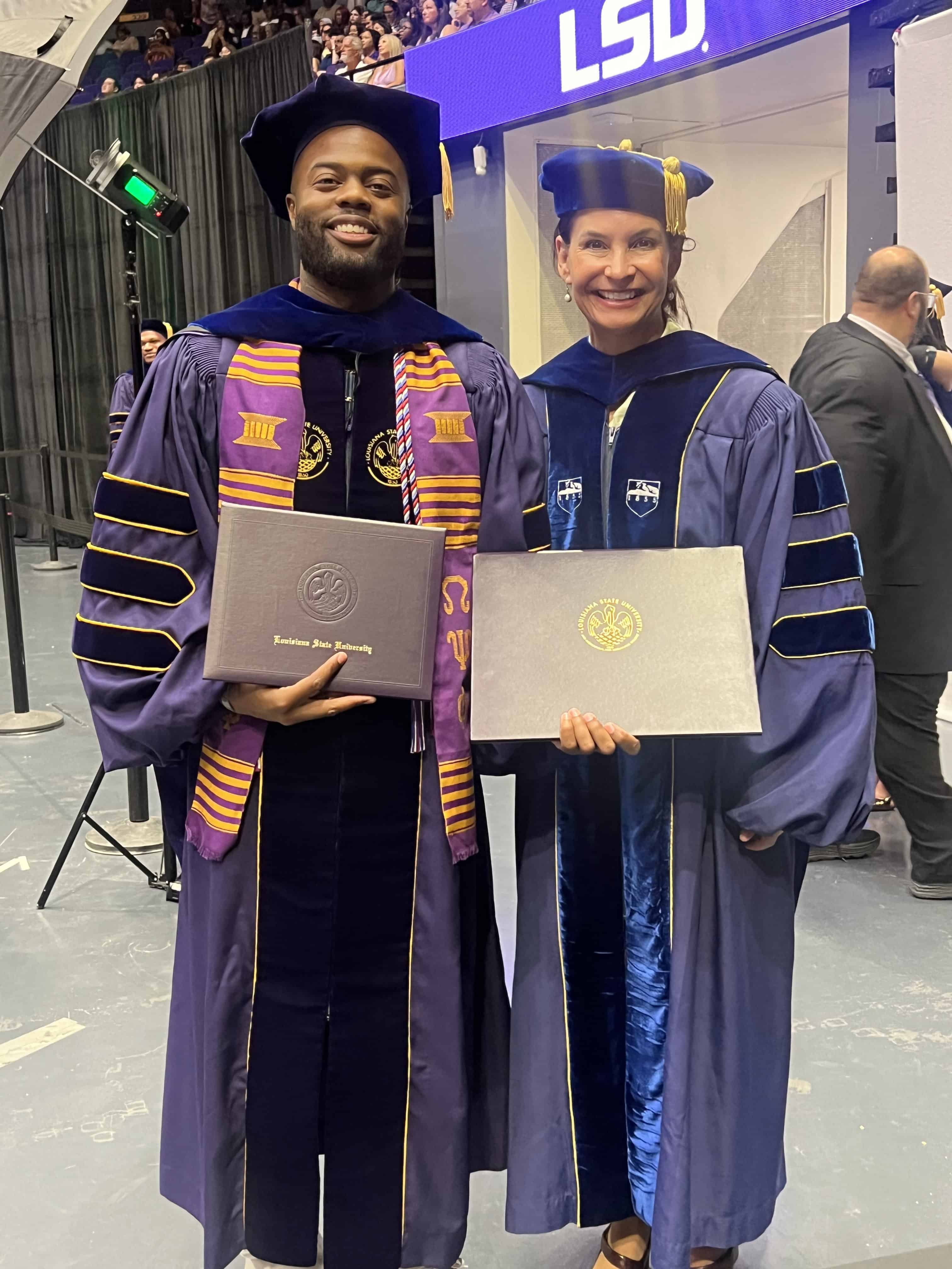 Andrae Holliday and Tracey Rizzuto in their commencement gowns