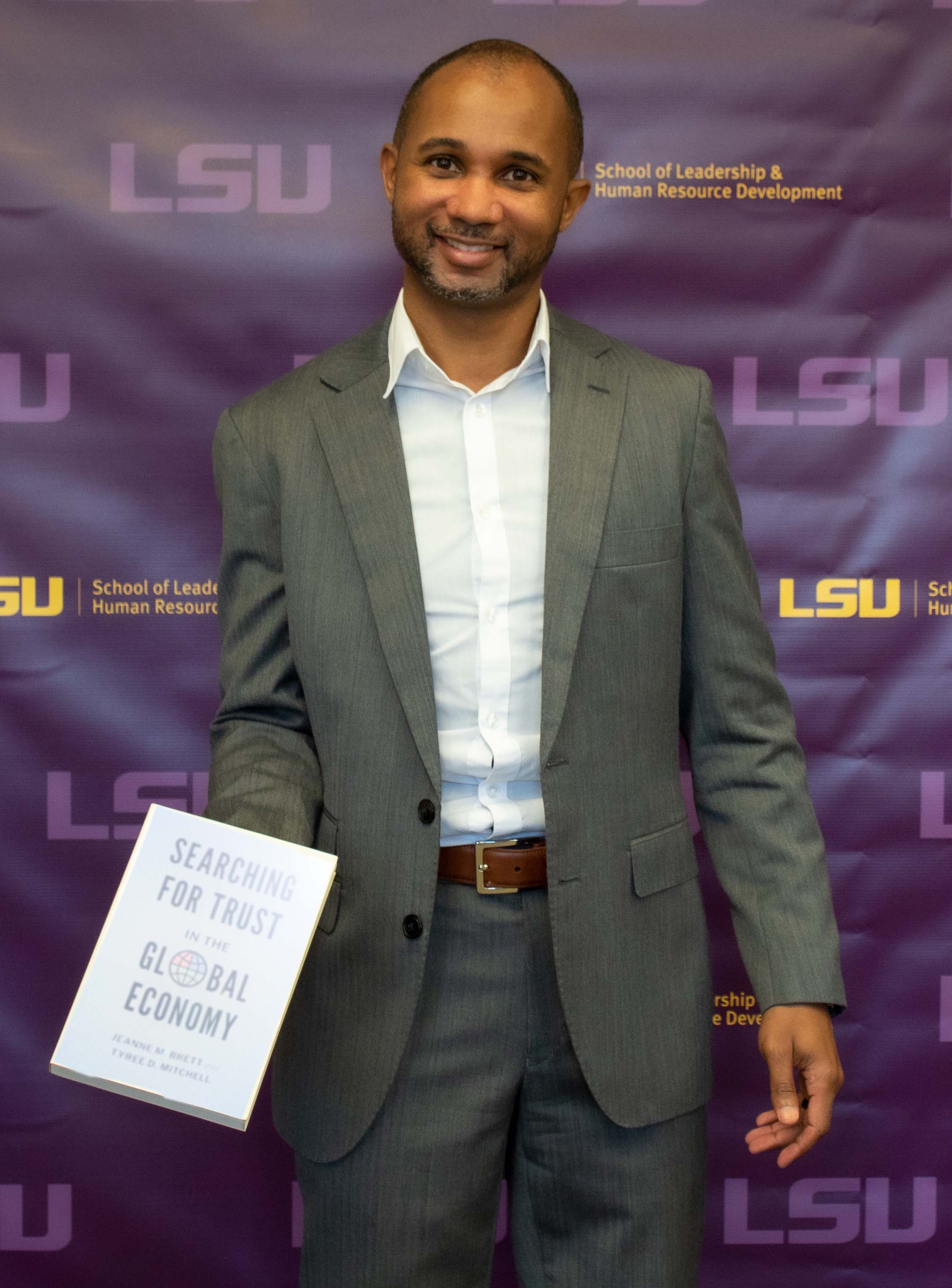 Photo of Tyree Mitchell holding his book.