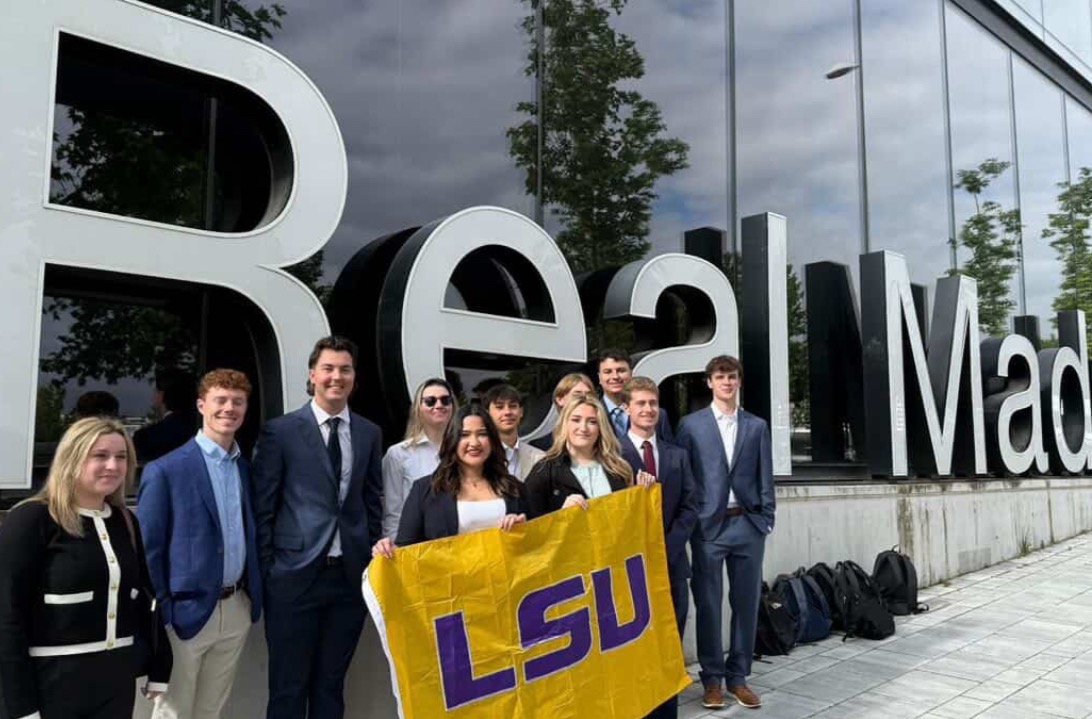 LSU students holding an LSU flag