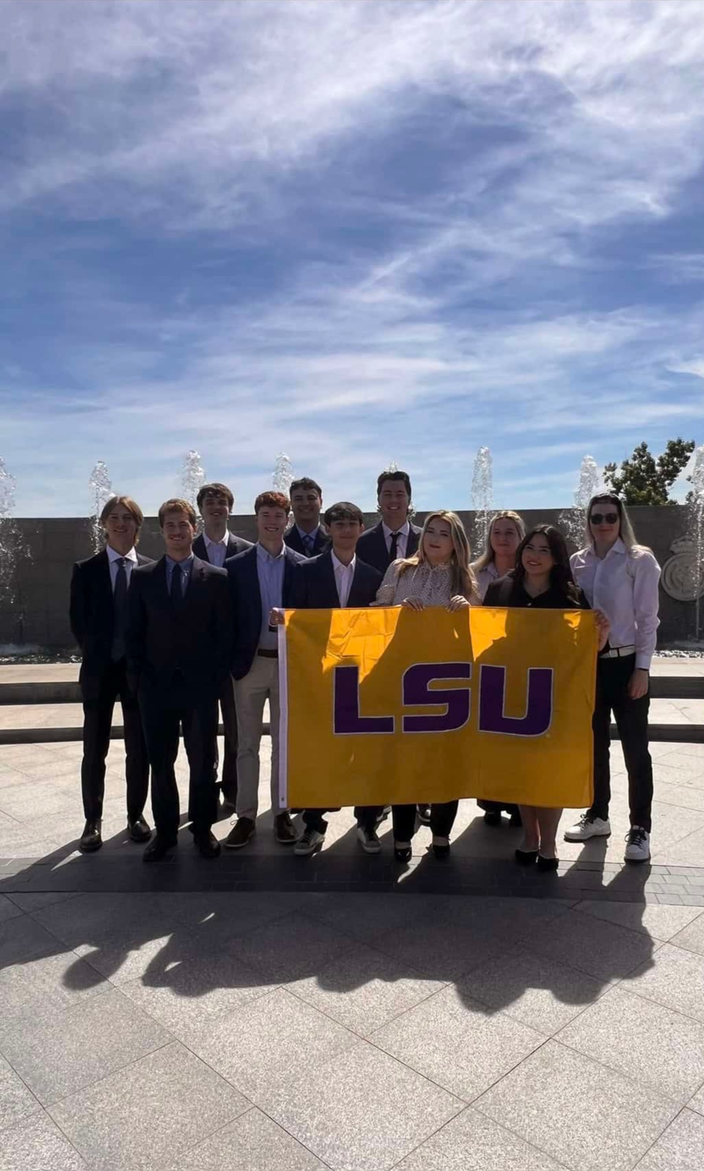 LSU Students holding an LSU flag