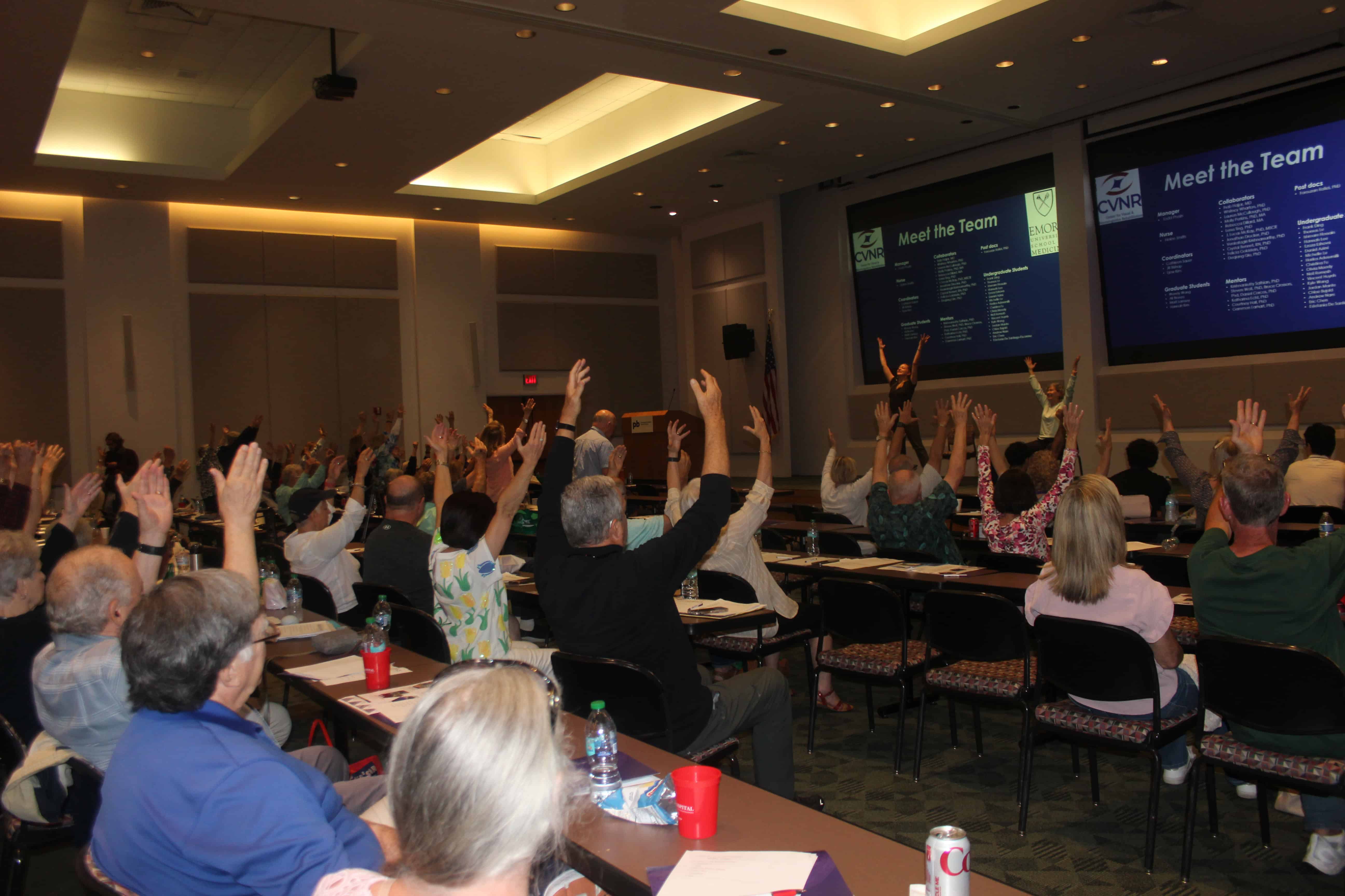 Conference attendees participating in an aerobics demonstration and the Annual Louisiana Parkinson's Conference