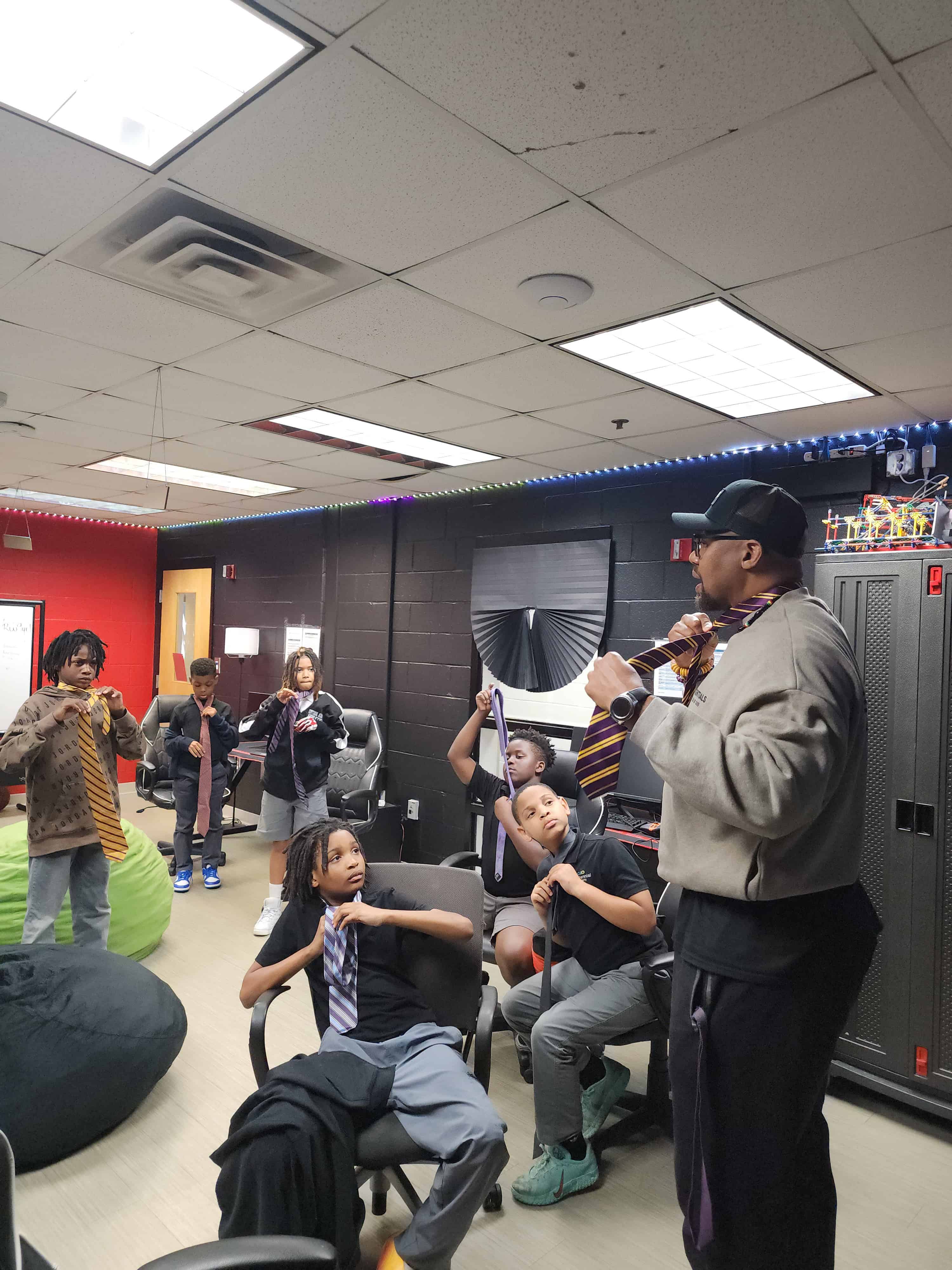 Chuck Wiley teaching a room full of boys how to tie a tie